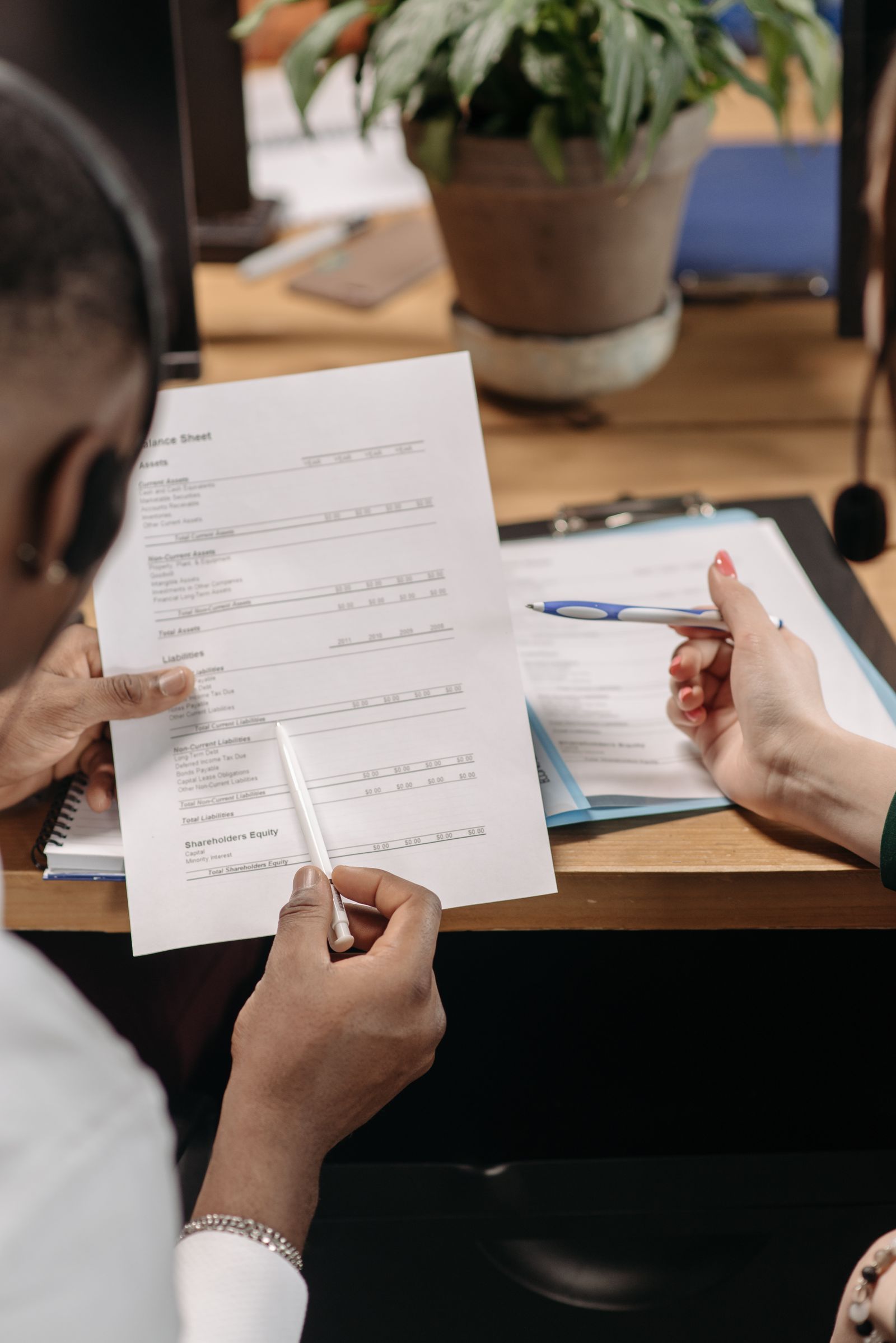 Professionals reviewing employee and payroll documents